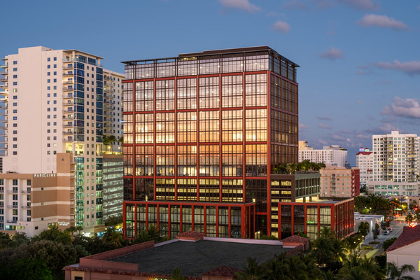 A commercial building in the skyline at twilight.