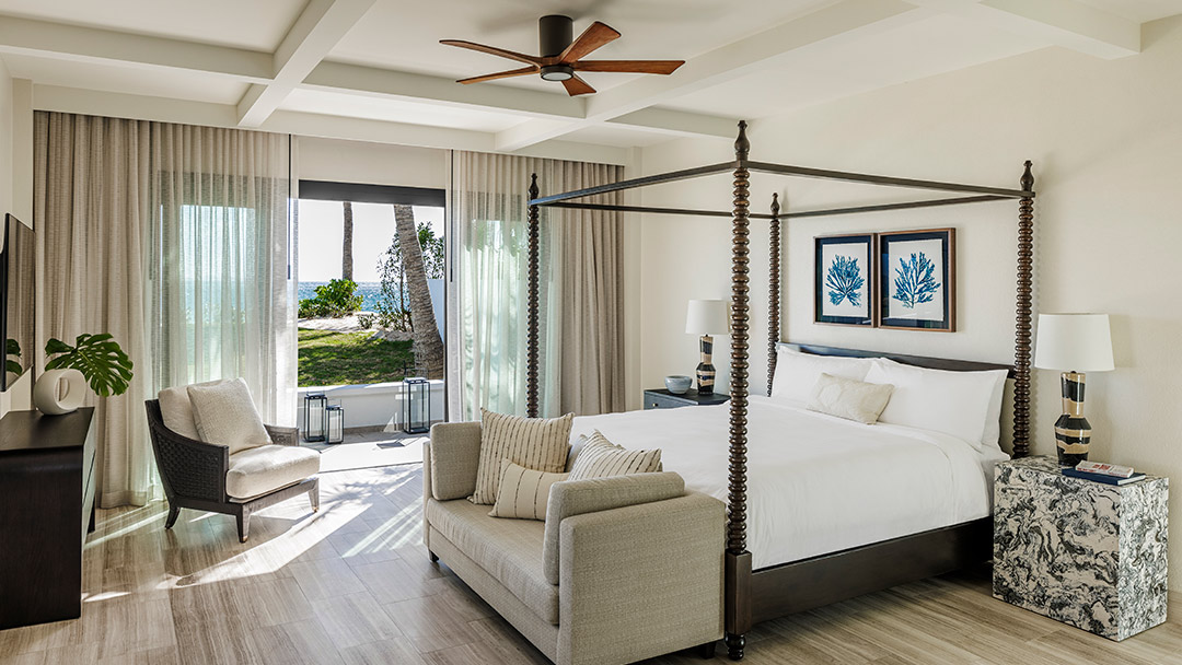 guestroom with poster bed and ocean view