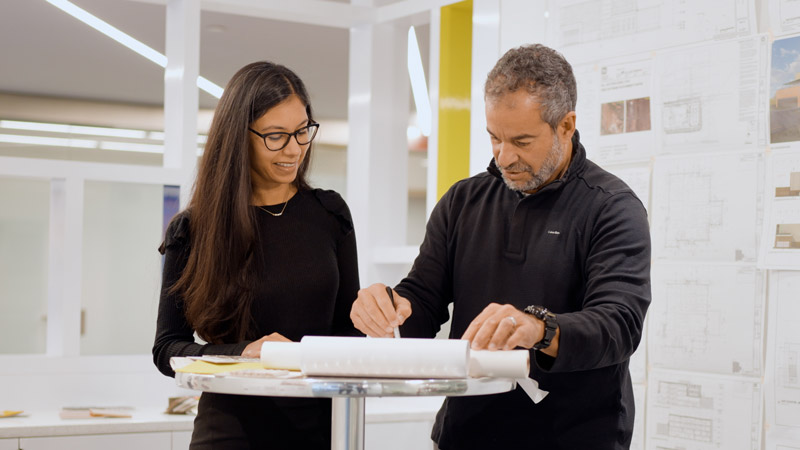 Pablo Quintana mentors a young workplace design teammate in the Washington, D. C. Studio of LEO A DALY