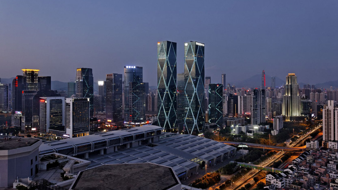 four towers enveloped in glass feature retail restaurant